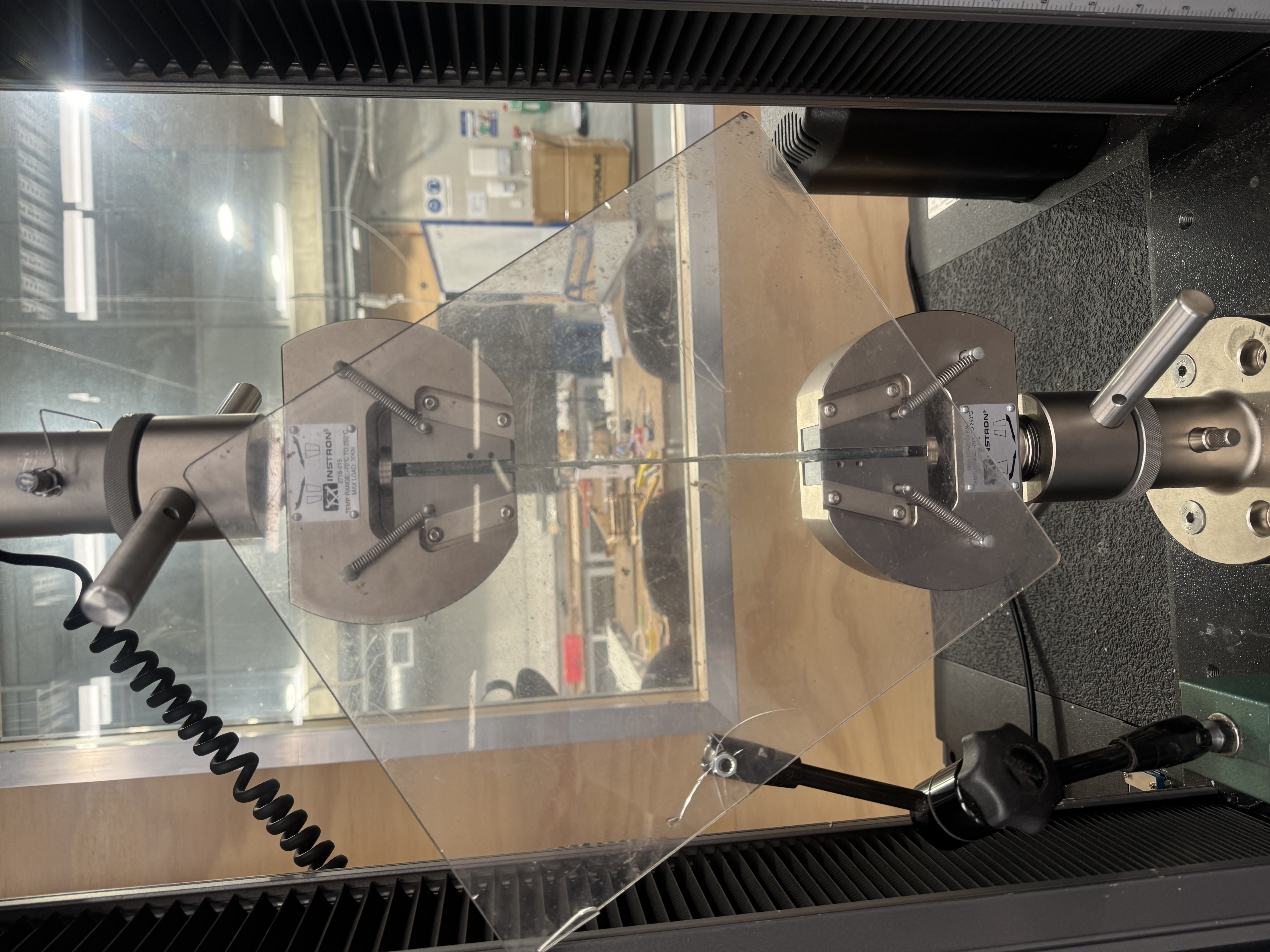 Composite test specimen mounted in an Instron tensile testing machine